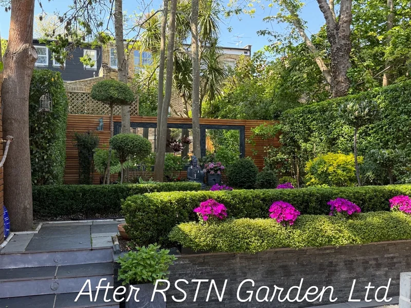 A finished garden of clipped hedges and flowering beds